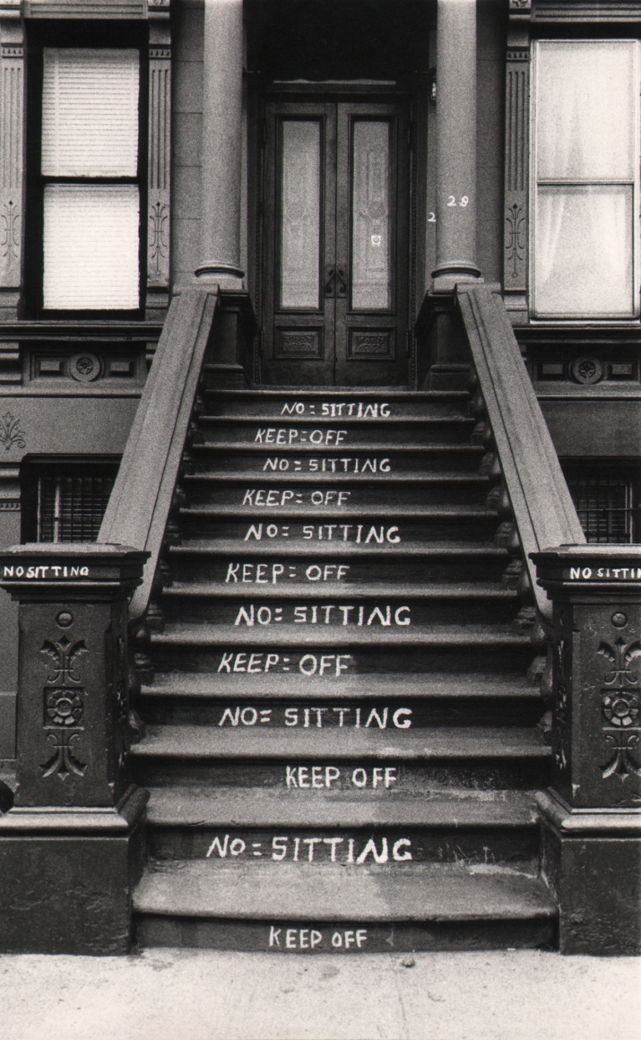 26. Beuford Smith, NO and KEEP OFF, Harlem, ​1982. A building stoop with "No sitting" and "Keep off" written on alternating steps.