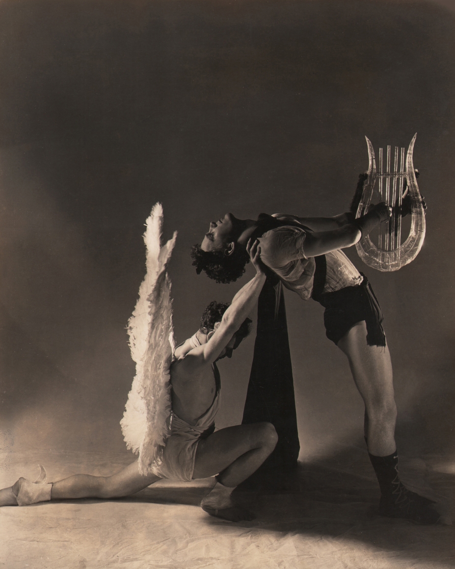 George Platt Lynes, Apollo & the Muses, Lew Christensen & William Dollar, Balanchine's Orpheus & Eurydice, ​1936. Male figure holding a harp leans against a kneeling angel figure supporting him by the shoulders.