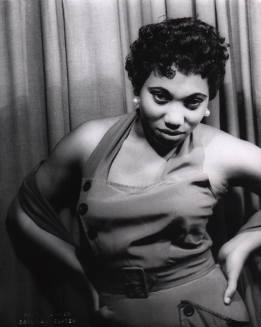 Carl Van Vechten, Leontyne Price in Porgy & Bess, ​1953. Subject poses against a curtain with hands on hips, looking to the camera.