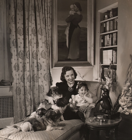 Louise Dahl-Wolfe, Mrs. Howard Dietz, Chairman of the Allied Relief Ball, 1942, A woman sits on a chaise with a small child and four small dogs.