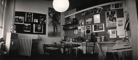02. Anthony Barboza, My Studio, 10 West 18th Street, NYC, 1970s. Wide shot of a studio space with prints all over the two visible walls.