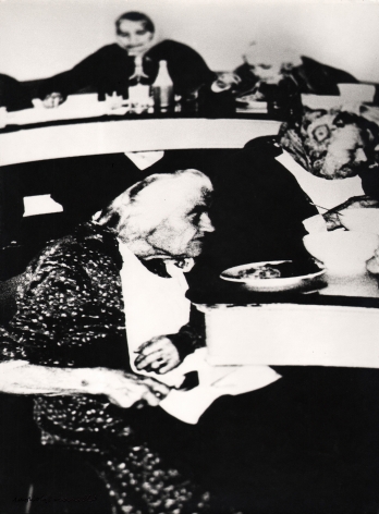 04. Mario Giacomelli, Verrà la morte e avrà i tuoi occhi, 1966–1968. High contrast image. Seated old women eating a meal (two in foreground, two in background).