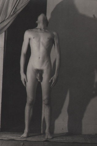 PaJaMa (Jared French), John Butler, ​1943. Nude male figure with head turned upward, a wide shadow cast on the wall behind him.