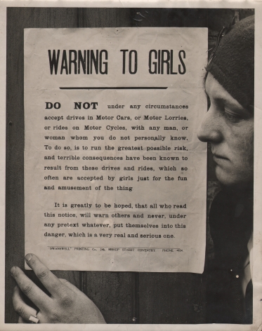 1. General Picture News, Churches Warning to Girls, c. 1920. A woman in profile on the right of the frame with one hand on a pasted sign that begins: "Warning to girls: Do not under any circumstances accept drives in Motor Cars, or Motor Lorries, or rides on Motor Cycles, with any man, or woman whom you do not personally know..."