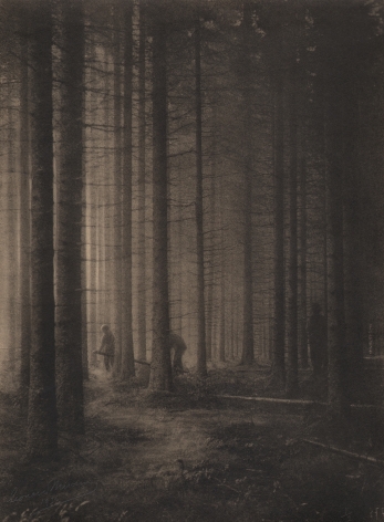 01. Léonard Misonne, Les bucherons, c. 1934. Three lumberjacks amongst tall trees. Sepia-toned print.