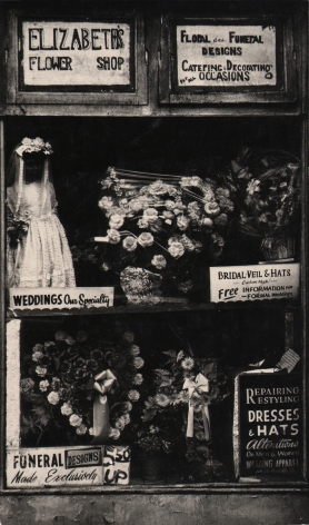 2. Beuford Smith, Harlem, NY, ​n.d. Shop window of "Elizabeth's Flower Shop" with various floral arrangements and signs describing services.