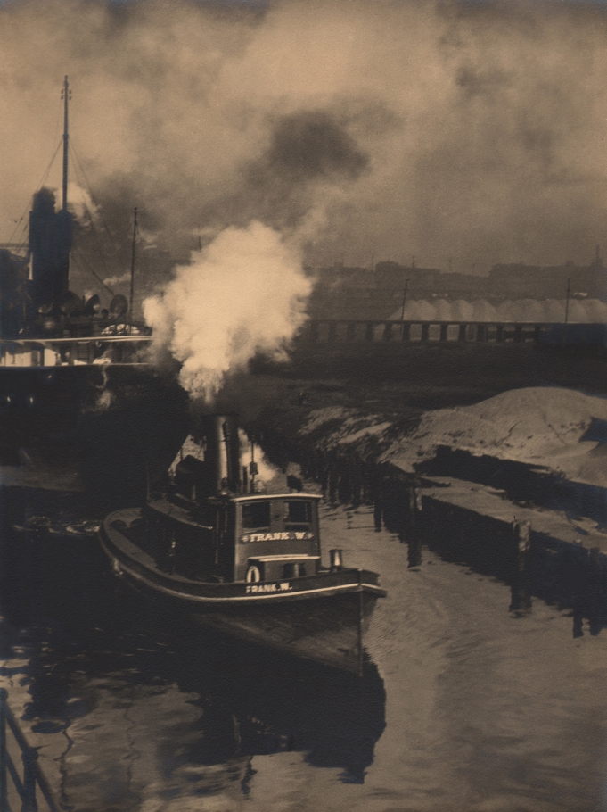 Margaret Bourke-White, 'Frank W.' on the Cuyahoga, c. 1929. Small steam ship marked "Frank W." in the water near a dock.