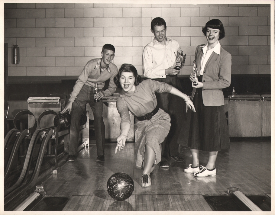 Ralph Bartholomew, Pepsi-Cola, ​1950. A teenager bowling while three other teens look on from behind holding glass bottles of Pepsi.